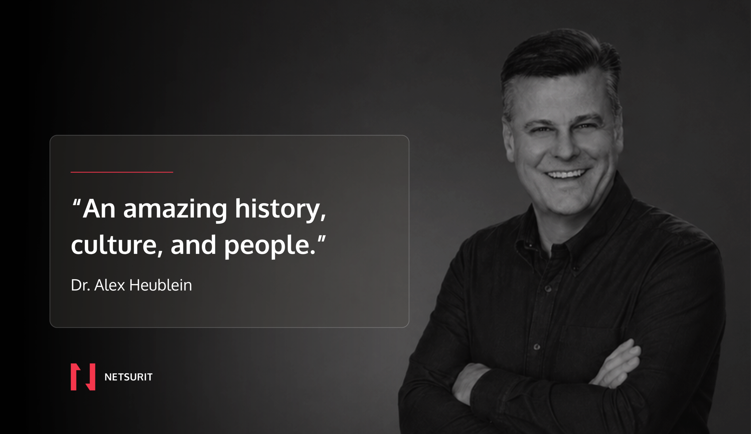 Testimonial quote card over a grayscale portrait: “An amazing history, culture, and people.” by Dr. Alex Heublein, with NETSIRIT logo bottom left.