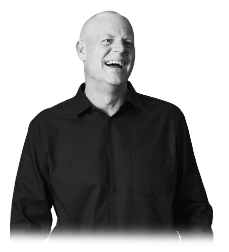 Smiling man wearing a black button-down shirt against a white background.