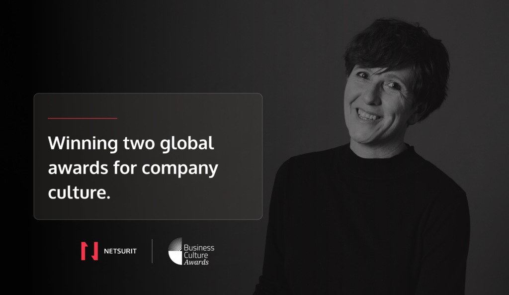 A woman smiling on a hero image with a text saying: Winning two global awards for company culture" with Netsurit and Business Culture Awards logo at the bottom.