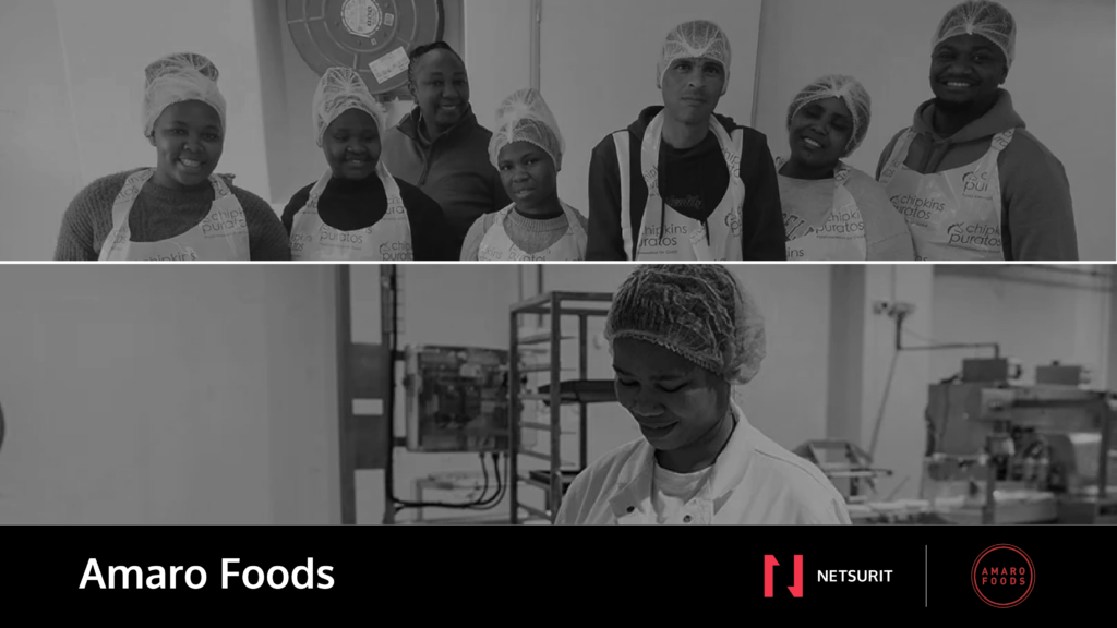 Group of diverse workers in hairnets and aprons posing in a food production facility.